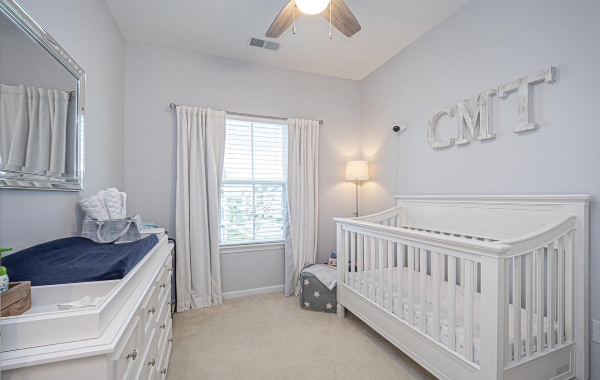 Neutral gray painted nursery with white crib
